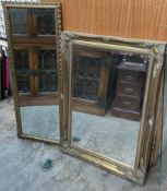 A gilt wall mirror of rectangular form decorated with flowers and leaves together with another