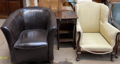 A brown leather upholstered arm chair together with a cream upholstered arm chair and a mahogany