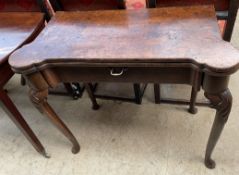 A walnut card table with a shaped foldover top with a baize interior and counter wells on leaf