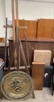Two easels together with a brass wall plaque,