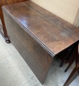 A 19th century oak gateleg dining table of rectangular form with drop flaps on square legs