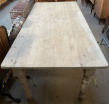 A pine refectory table, the planked top with rounded corners on turned legs, 91cm wide x 231.