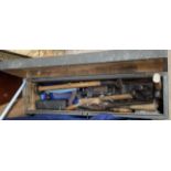 A pine chest, containing woodworking tools, including hammers, saws,
