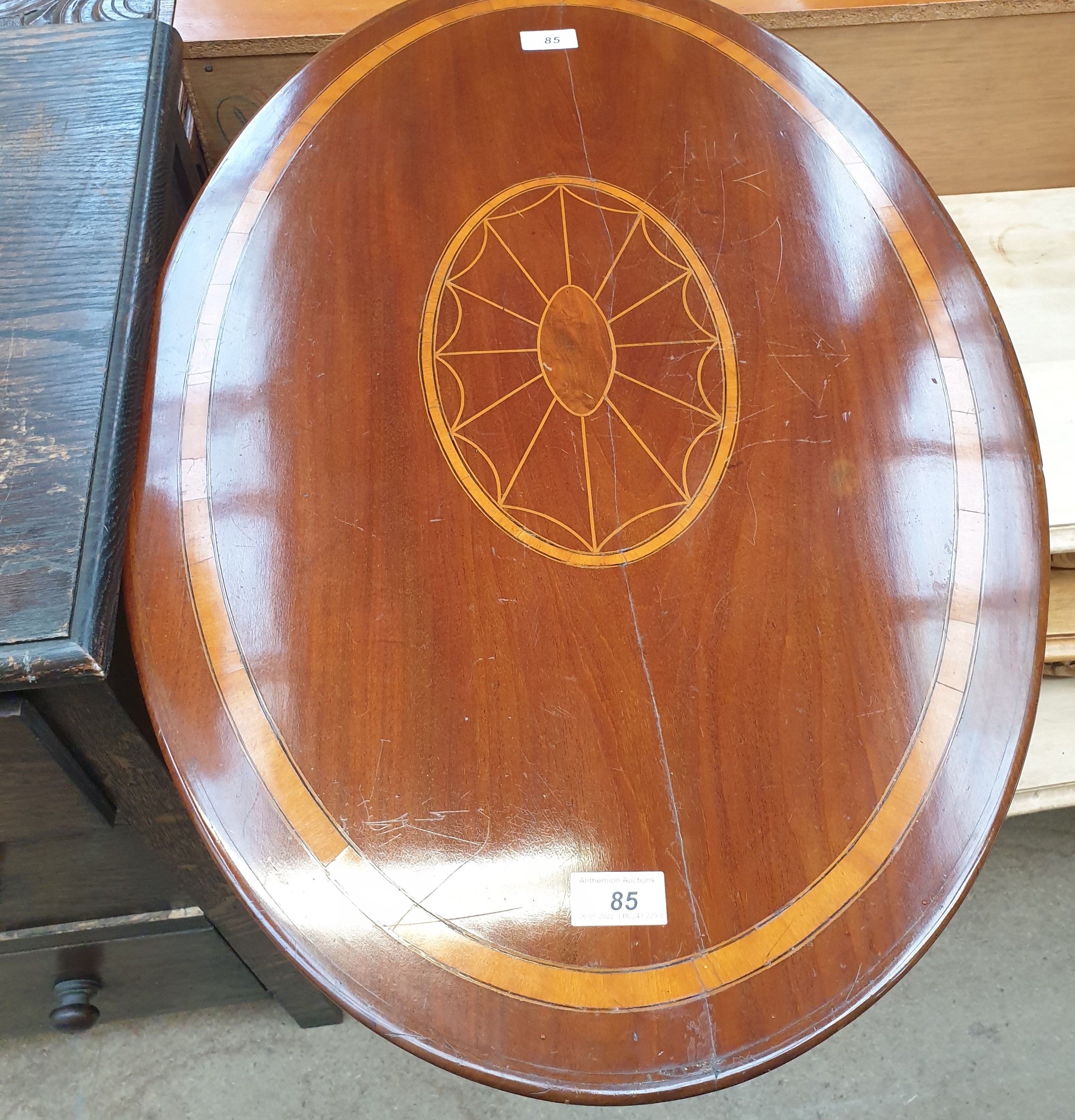 An Edwardian mahogany occasional table with an inlaid oval top on a tapering column and three leaf - Image 2 of 2