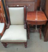 A Victorian nursing chair with a chequer pad upholstery on turned legs together with a Victorian