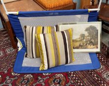 A Tomy bed guard together with two striped cushions and a cricketing print