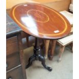 An Edwardian mahogany occasional table with an inlaid oval top on a tapering column and three leaf