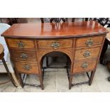 A 19th century mahogany sideboard with a D shaped top above seven drawers on square tapering legs