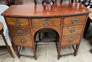 A 19th century mahogany sideboard with a D shaped top above seven drawers on square tapering legs
