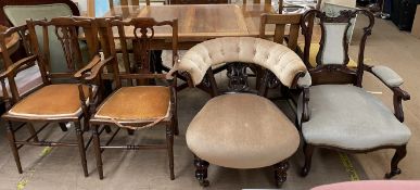 A Victorian rosewood horseshoe shaped chair with a button upholstered pad and a carved back above a