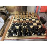 An ebonised and natural chess set, king 9cm high, pawn 4.