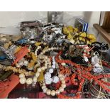 Assorted costume jewellery including brooches, beaded necklaces,