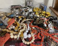 Assorted costume jewellery including brooches, beaded necklaces,