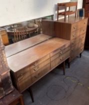 A mid 20th century walnut dressing table and matching dressing chest,