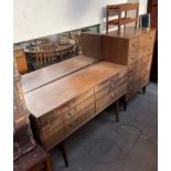 A mid 20th century walnut dressing table and matching dressing chest,