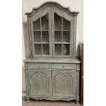 A continental painted bookcase with an arched top, glazed doors and sides,