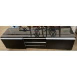 A black high gloss and aluminium television low side cabinet