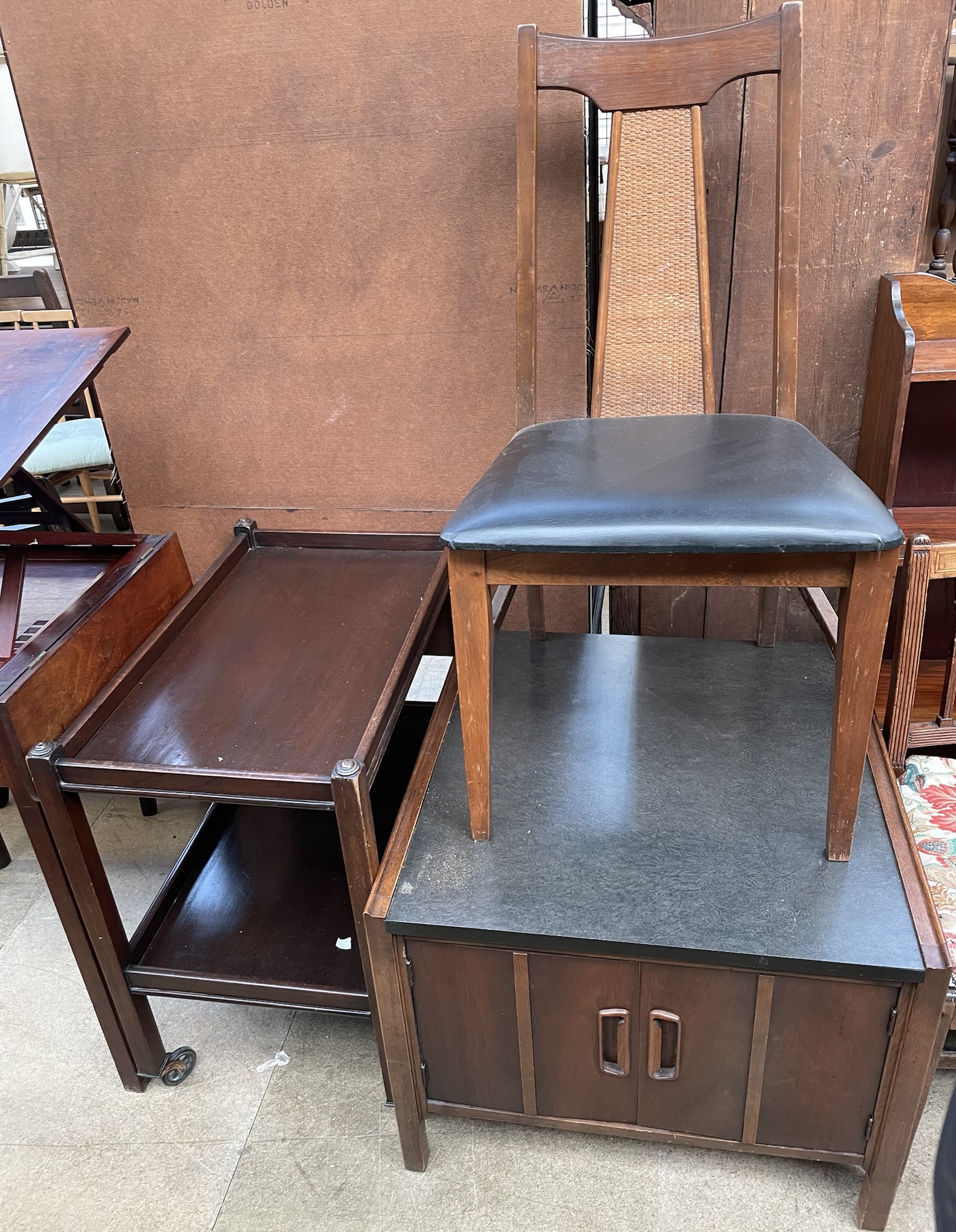A mid 20th century teak dining chair together with a teak and ebonised side cabinet and a tea