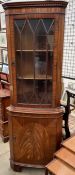 A reproduction mahogany standing corner cupboard