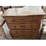 A 19th century French chest with a serpentine top and four long drawers on flattened bun feet