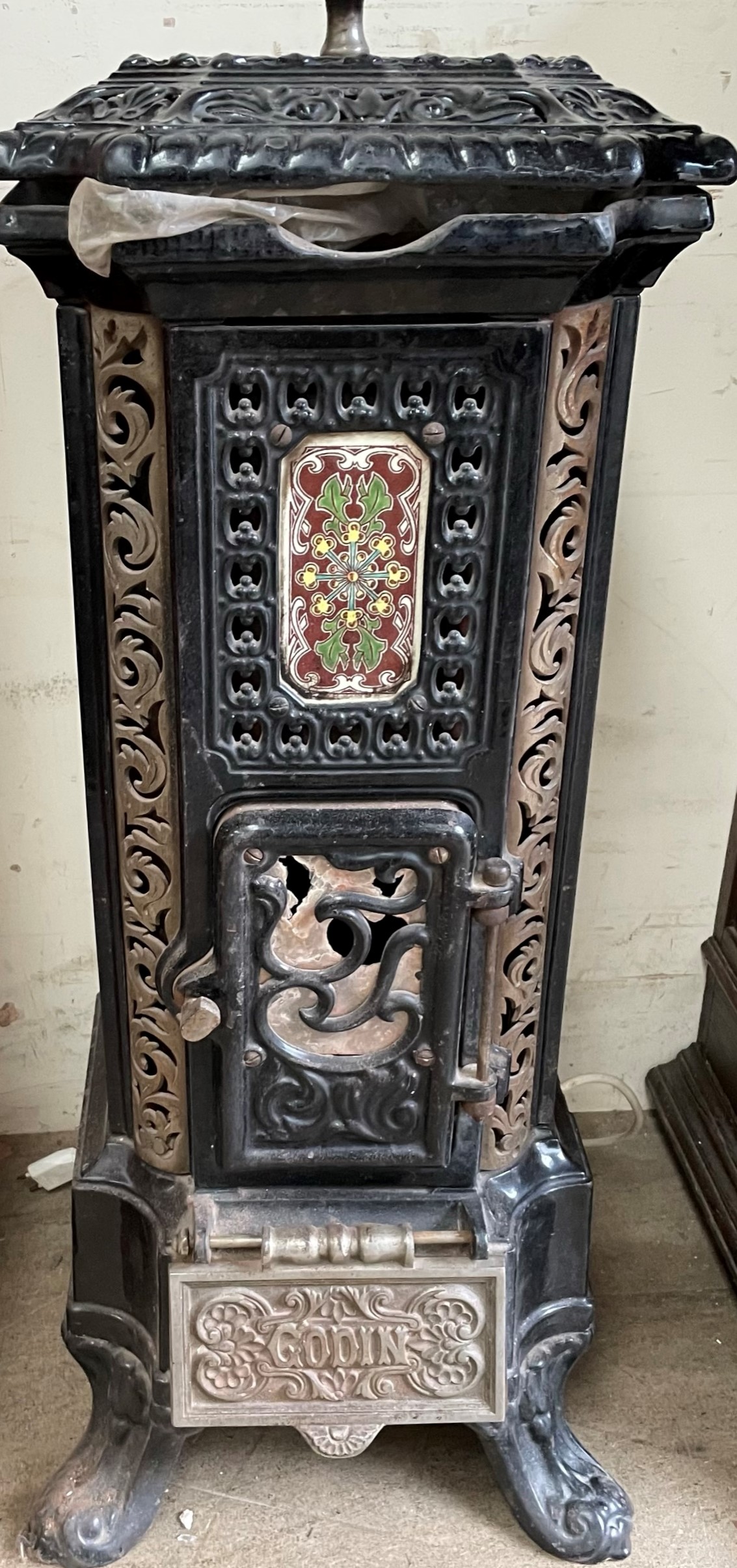 A French Godin enamelled cast iron stove with canted corners of square form