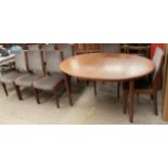 A mid 20th century teak G-Plan extending dining table and eight chairs