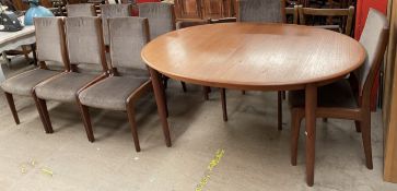 A mid 20th century teak G-Plan extending dining table and eight chairs