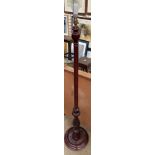 A modern standard lamp with a carved baluster column and a circular base