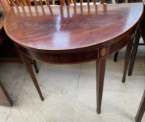 A 19th century mahogany card table with a crossbanded fold over top with a baize interior on square