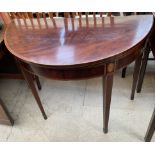 A 19th century mahogany card table with a crossbanded fold over top with a baize interior on square