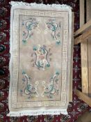 A cream ground Chinese rug,