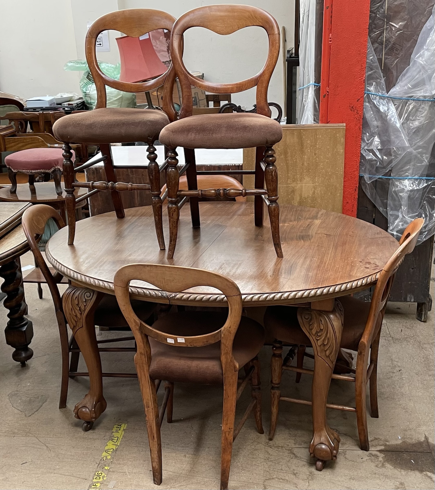 An early 20th century mahogany extending dining table together with a set of six Victorian Balloon