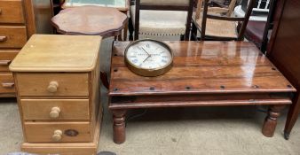 A modern low coffee table with a planked top on turned legs together with a pine bedside chest,