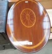 An Edwardian mahogany occasional table with an inlaid oval top on a tapering column and three leaf