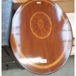 An Edwardian mahogany occasional table with an inlaid oval top on a tapering column and three leaf