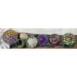 A Caithness Myriad paperweight together with other glass paperweights
