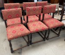 A set of six upholstered oak dining chairs with pad backs and seats