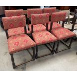 A set of six upholstered oak dining chairs with pad backs and seats