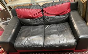 A black and red leather two seater settee