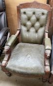 An Edwardian library chair with a green leather button upholstered back, with a pad seat and arms,