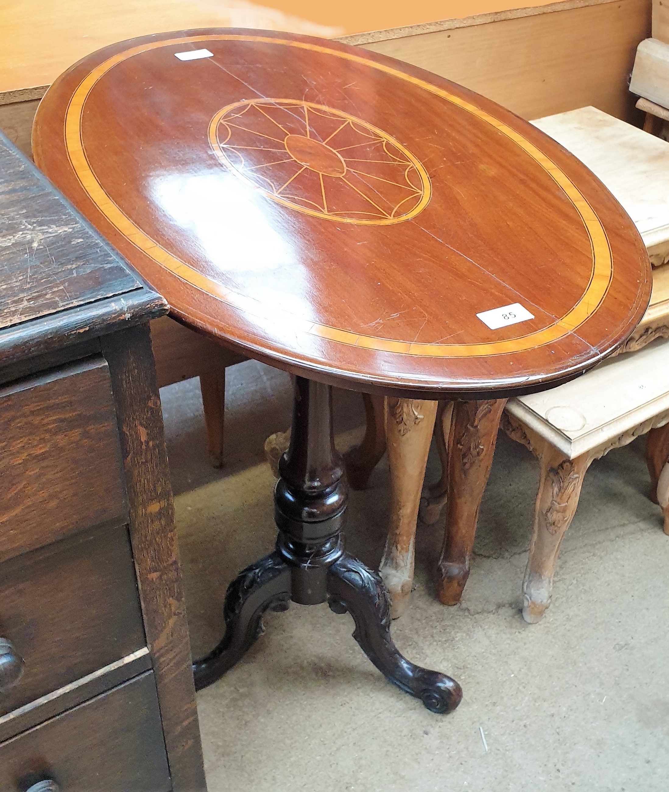 An Edwardian mahogany occasional table with an inlaid oval top on a tapering column and three leaf - Image 2 of 2