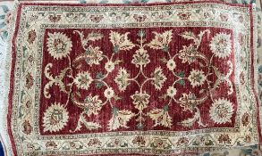 A Pakistan wool rug with a red ground