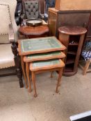 A 20th century nest of three tables with leather inset tops
