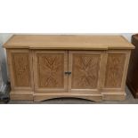 A 20th century sideboard with a pair of central cupboard doors on a plinth base
