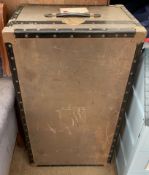 A white metal steamer trunk,