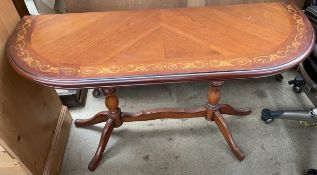 A modern side table with marquetry decoration on turned legs