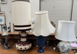 A mid 20th century pottery table lamp with cream and brown body and a tall shade together with two