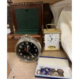 A Goliath Repeater alarm clock together with a an Acctim clock, p;in badges,