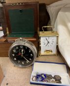 A Goliath Repeater alarm clock together with a an Acctim clock, p;in badges,