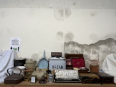 A brass carriage timepiece together with an enamel bread bin, stoneware foot warmers,